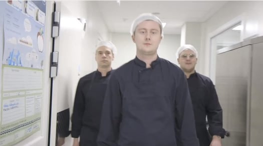 Chefs walking into a kitchen