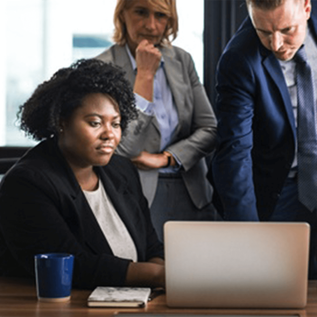 Business people, talking around a computer